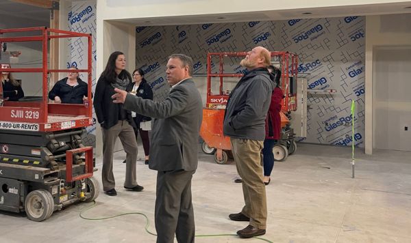 Corvallis School District staff, School Board and District Bond Oversight Committee members look at the new College Hill servery and cafeteria