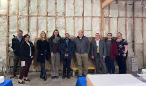 District staff, school board, and bond oversight committee members in the new office at College Hill High School