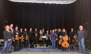 School board posing with orchestra