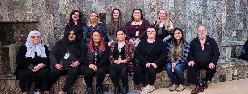 Family advocacy team of twelve people posing for picture