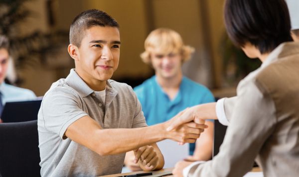 Student shaking hands with an interviewer