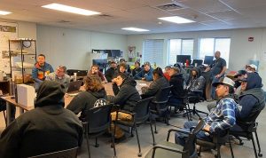 Students and construction staff watching presentation