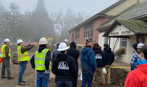 Students and construction staff looking at the front of College Hill