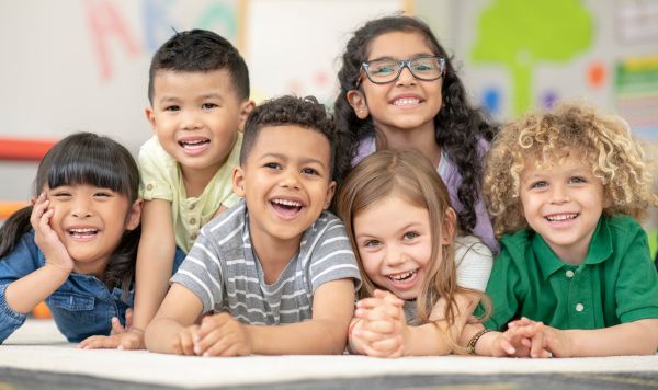 Kindergarten students smiling at the camera