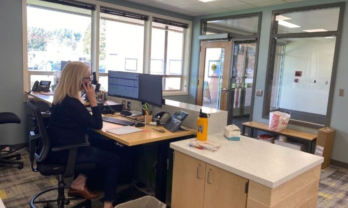 Letitia Carson main office with desks and woman on phone