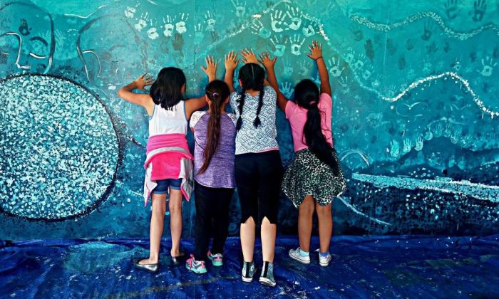 Elementary kids working on a mural