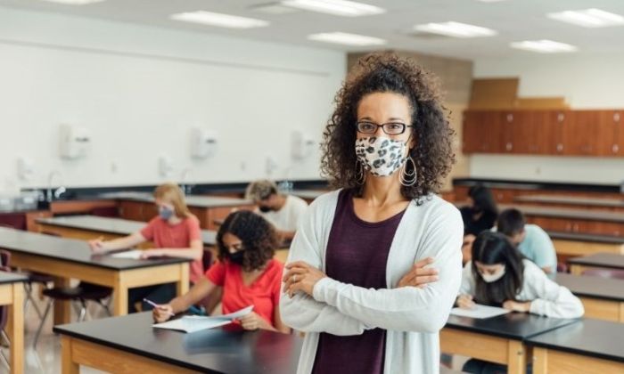 teacher in classroom wearing mask